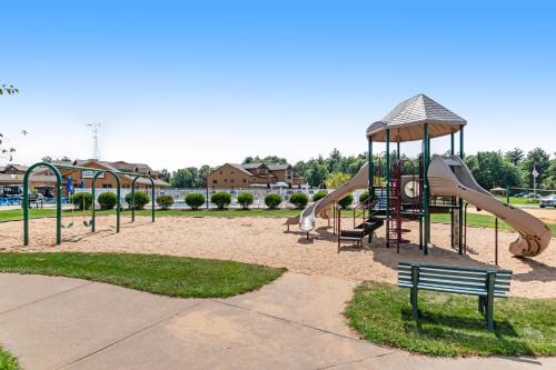 a park with a playground with slides and a bench at Tigers Den - Lower in Arkdale