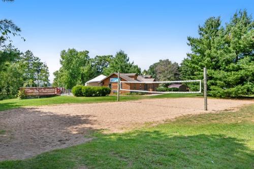 a volleyball court with a house in the background at Tigers Den - Lower in Arkdale
