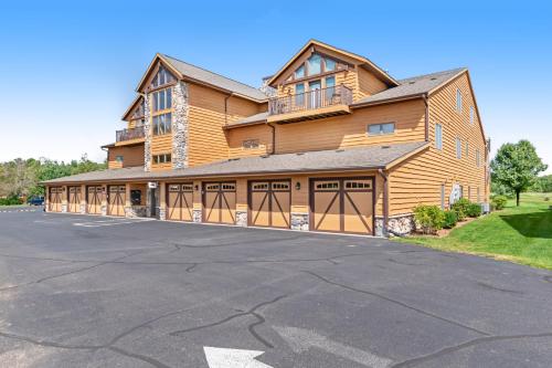 a large wooden house with two garage doors at Tigers Den - Lower in Arkdale