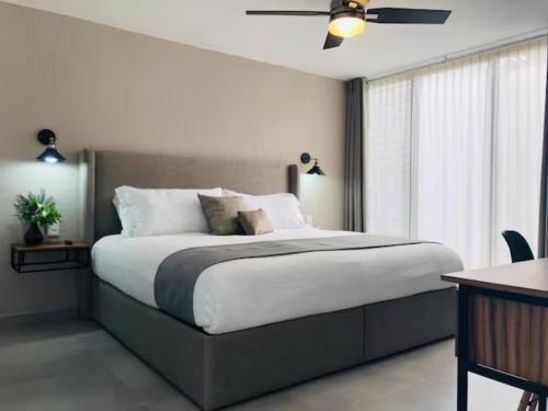 a bedroom with a large bed with a ceiling fan at Urban Chapalita in Guadalajara