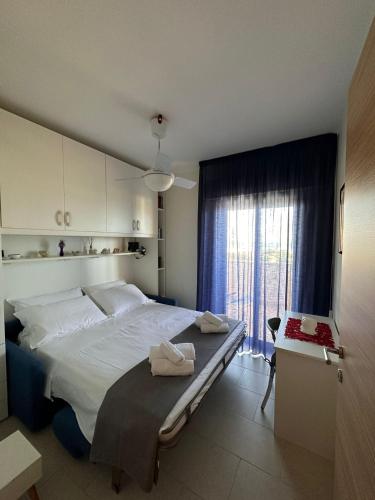 a bedroom with a large bed and a window at La casa al Mare in Erice