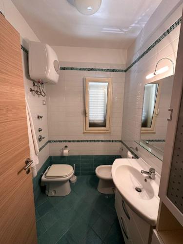 a bathroom with a toilet and a sink at La casa al Mare in Erice