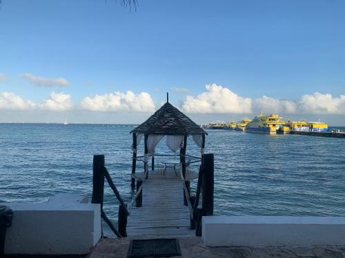 a dock with a gazebo on the water with boats at Casa CARIBE Cancun in Cancún