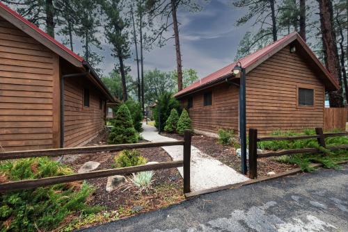 a couple of buildings with a fence in front of it at Shadow Mountain Lodge and Cabins in Ruidoso
