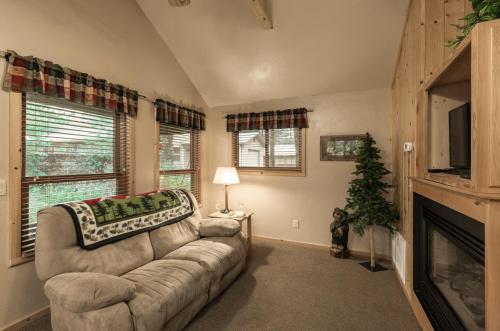 a living room with a couch and a christmas tree at Shadow Mountain Lodge and Cabins in Ruidoso