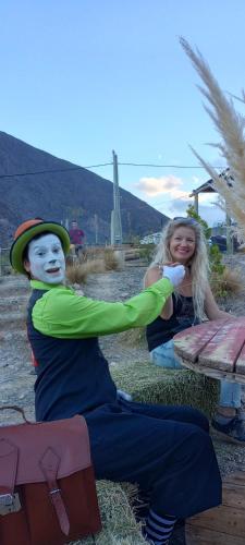 two children with painted faces sitting next to a picnic table at Cabañas Piquillin Potrerillos Mendoza in Potrerillos