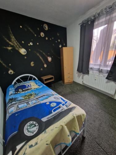 a bedroom with a bed with a car on the wall at Central home in Brussels
