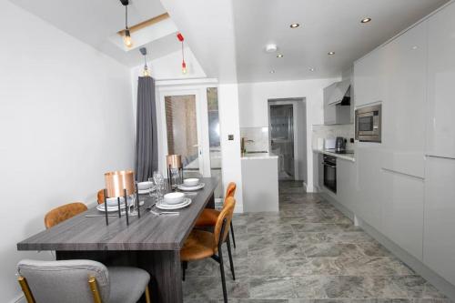 a kitchen and dining room with a table and chairs at Modern and Luxury House for 8 in Gillingham