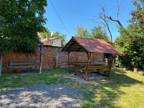 a picnic table with a roof in a yard at Будинок для відпочинку Патріція in Berehove