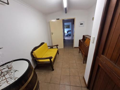 a hallway with a yellow couch in a room at La Château B&B in Springs