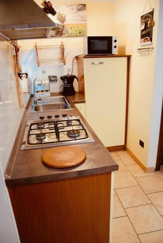 a kitchen with a stove top and a refrigerator at Maisonette in Nus