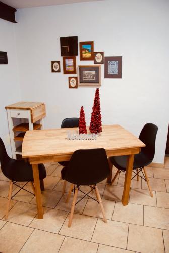 a dining room table with two christmas trees on it at Maisonette in Nus