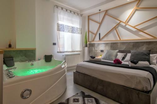 a bedroom with a large bed and a tub at saige holidays in Alghero