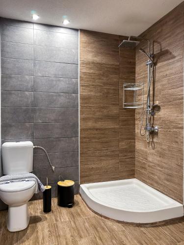 a bathroom with a toilet and a bath tub at MyseA VillasNikiti in Nikiti