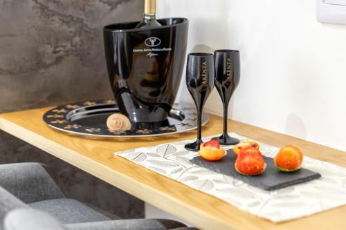 a table with a juicer and some fruit on a cutting board at saige holidays in Alghero