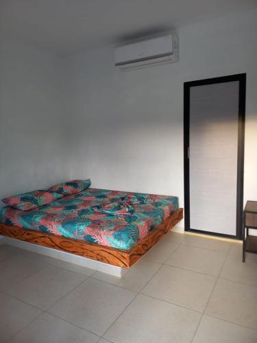 a bed sitting in a room with a mirror at finca campestre las heliconias in Puerto Triunfo