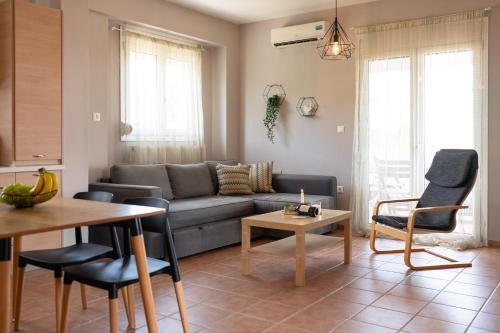 a living room with a couch and a table at MyseA VillasNikiti in Nikiti