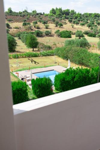 a view of a pool from a window at MyseA VillasNikiti in Nikiti