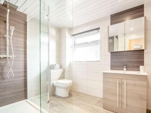 a bathroom with a toilet and a glass shower at 3 bed in Conwy 87866 in Penmaen-mawr