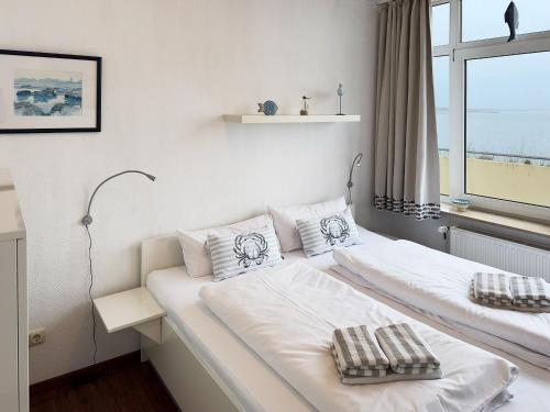 Ένα ή περισσότερα κρεβάτια σε δωμάτιο στο Haus Nordenlicht Ferienwohnung Wattkieker