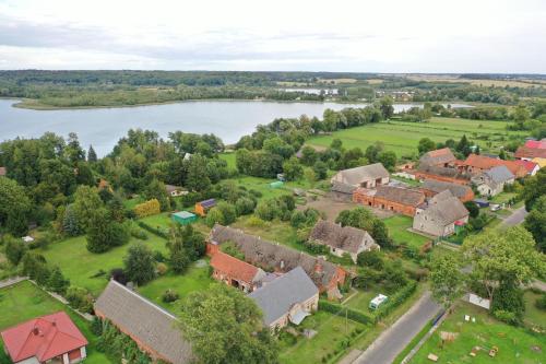 an aerial view of a house with a lake at Domek letniskowy drewniany nad Jeziorem Strzeszowskim nowy in Strzeszów