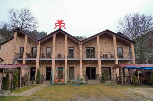 an old brick building with a cross on the roof at Royal Rest Townhouse in Dilijan