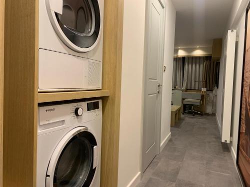 a washer and dryer in a hallway of a house at Deluxe Apartment at the seaside in Pasaport Alsancak Izmir in Konak