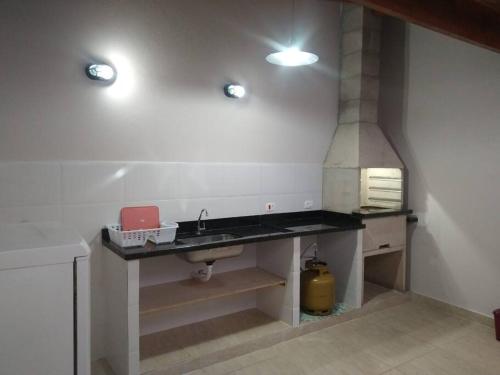 a kitchen with a sink and a stove at Casa em São Sebastião in São Sebastião