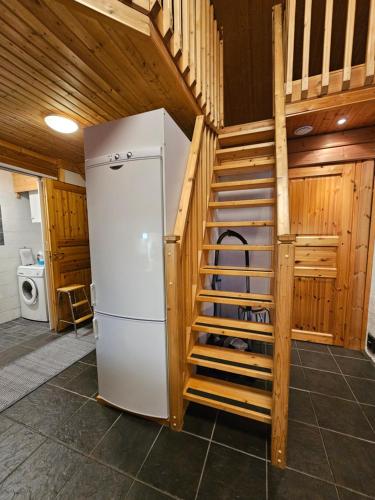 a white refrigerator in a room with a staircase at Tahko Villa Vaarna in Tahkovuori