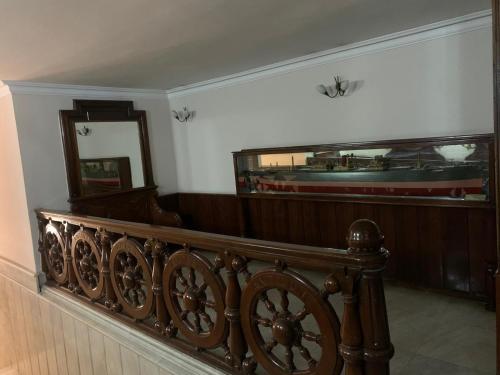 a room with a wooden railing and a mirror at Deluxe Apartment at the seaside in Pasaport Alsancak Izmir in Konak