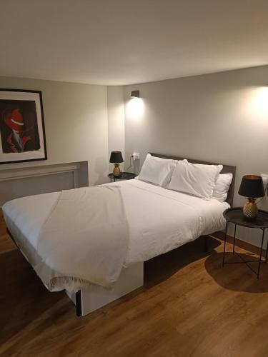 a bedroom with a large bed with white sheets and pillows at Apartamento Retiro in Madrid