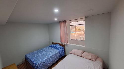 A bed or beds in a room at Casa de Verano en Mollendo