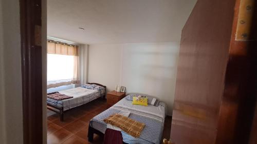 En eller flere senge i et værelse på Casa de Verano en Mollendo