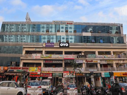 a large building with cars parked in front of it at OYO 82103 Hotel Galaxy in Surat