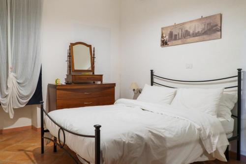 a bedroom with a bed with a mirror and a dresser at Le Maioliche in Saponara Villafranca