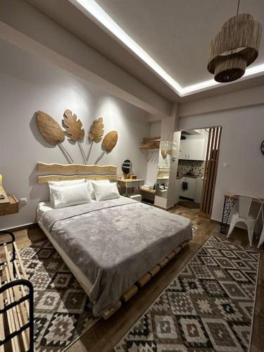 a bedroom with a large bed and a living room at Tiny Nest Sindos in Síndos