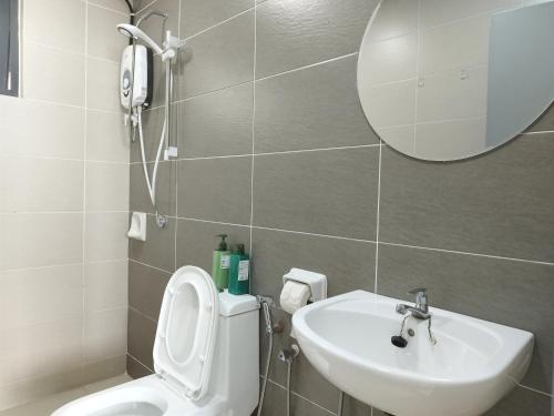 a bathroom with a toilet and a sink and a mirror at PuchongIsland WindyStay3R2B8Pax AT D'Island in Puchong