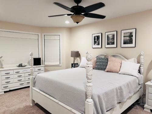 a bedroom with a white bed and a ceiling fan at Sopra Bella- 4 bedroom home in Corvallis