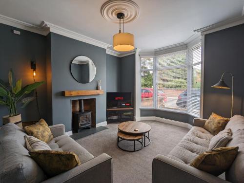 a living room with two couches and a fire place at Hill View in Great Ayton in Great Ayton