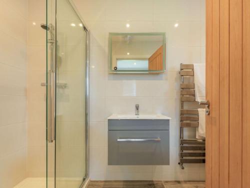 a bathroom with a sink and a glass shower at 2 Bed in Sherborne 87915 in Bradford Abbas