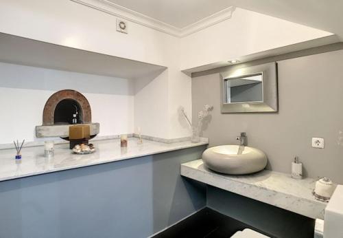 a white bathroom with a sink and a mirror at Villa Calçada in Santa Cruz