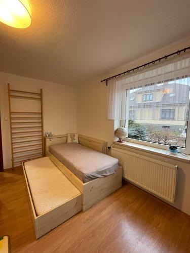 a bedroom with two beds and a window at Apartman Zelená hora in Žďár nad Sázavou