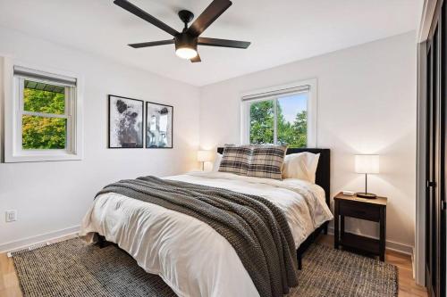 a bedroom with a bed and a ceiling fan at Luxury Cowdry Cottage Lake Home in Alexandria