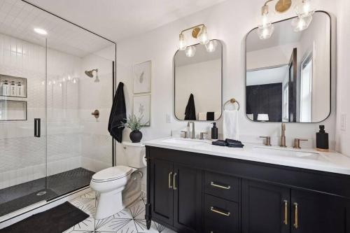a bathroom with a sink and a toilet and a shower at Luxury Cowdry Cottage Lake Home in Alexandria