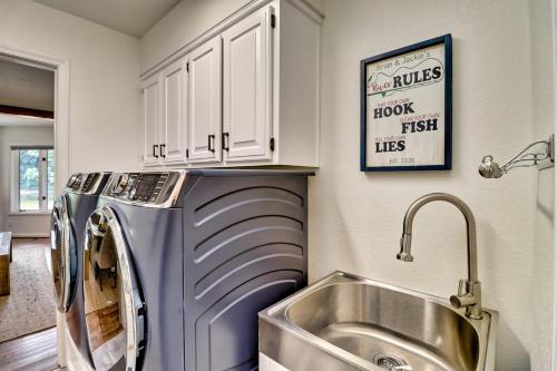 a kitchen with a sink and a washing machine at Cotter Home with Direct Access to White River! in Cotter