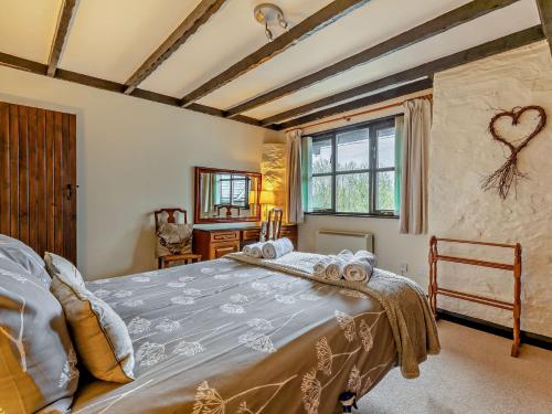 a bedroom with a large bed and a window at 2 Bed in Dulverton 90558 in Dulverton