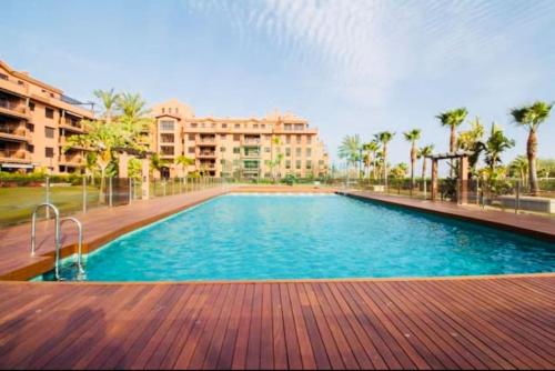 a large swimming pool in front of a building at La casa de Mateo Playa Granada in Motril