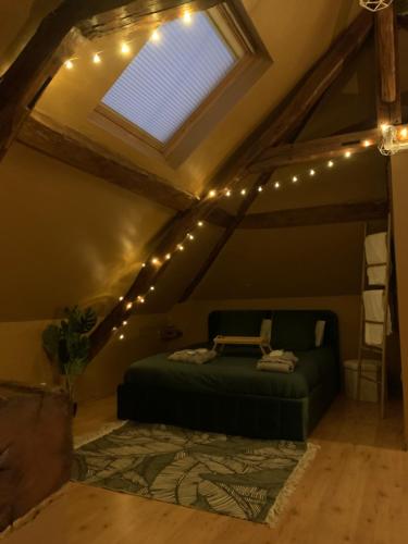 a bedroom with a bed with lights and a window at Les Almadies private Jacuzzi in Villeneuve-les-Sablons