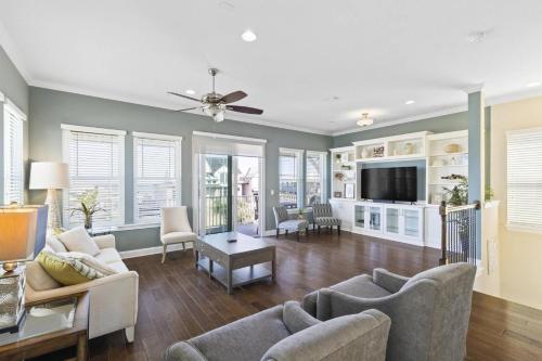 a living room with a couch and a tv at Sunset Inlet Luxury Oasis | Flagler Beach in Flagler Beach