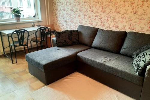 a living room with a couch and a table at Quiet and cozy 15 min bus to city center in Iru